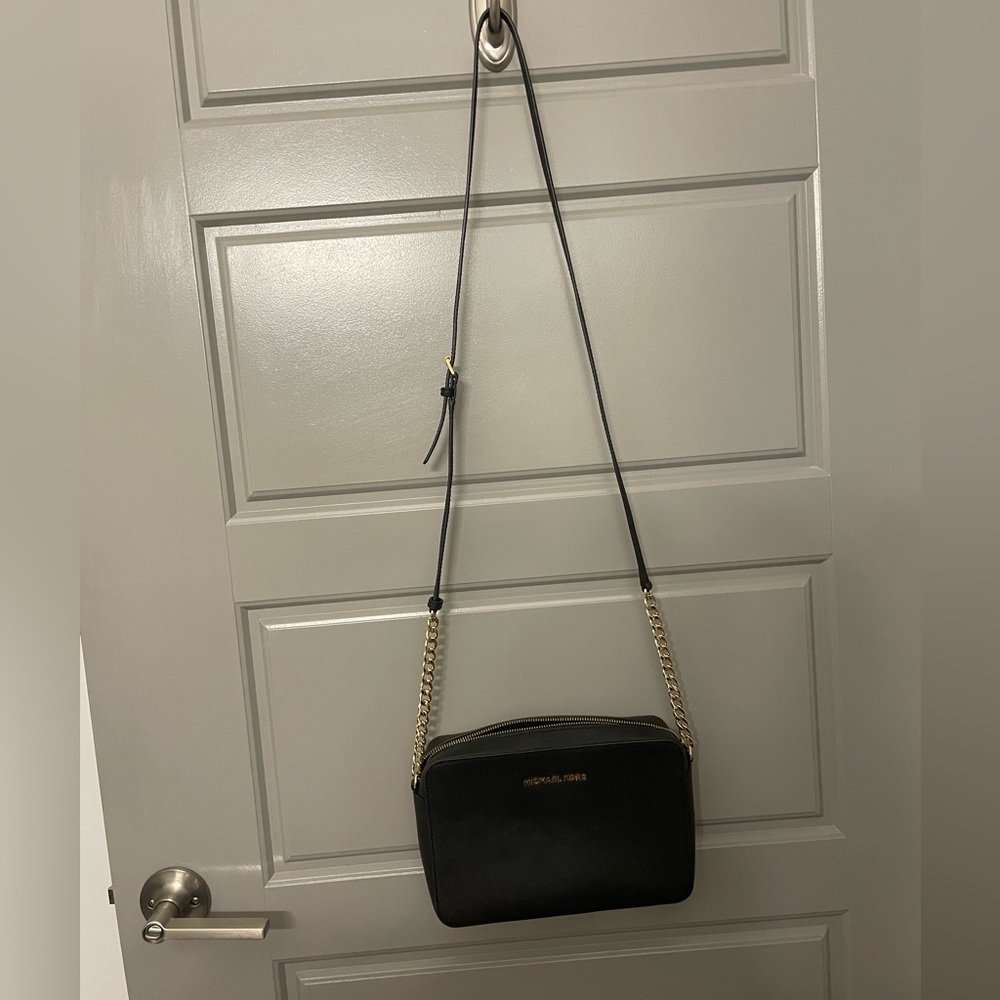 Michael Kors Jet Set East West Crossbody in black and gold.